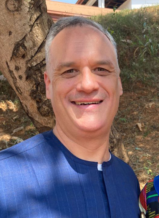 Picture of Jason wearing a dark blue African style shirt.